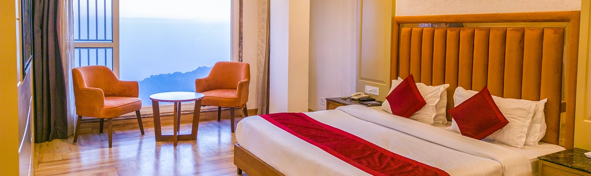 Luxury Inn Mussoorie hotel bedroom with window seating