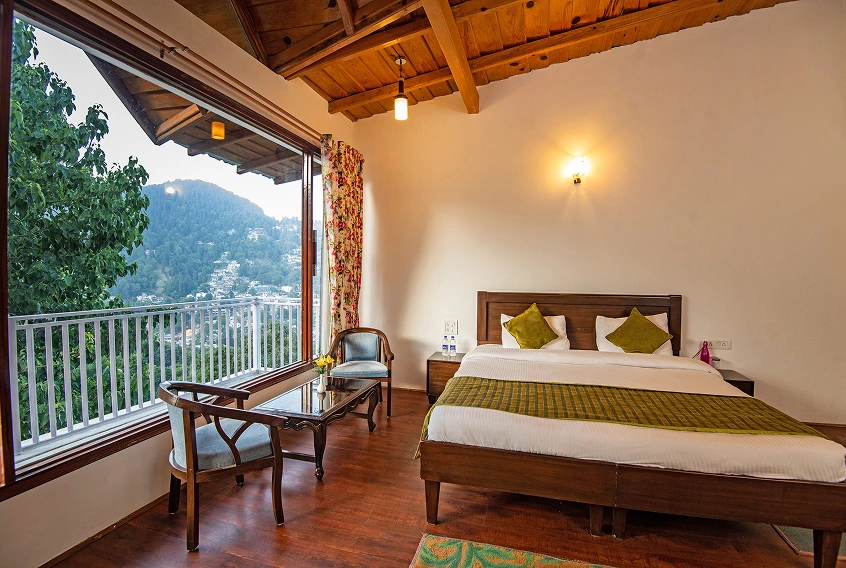 Xomotel room with a balcony and mountain views