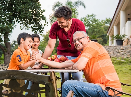 Family enjoying a meal outdoors at a Xomotel stay