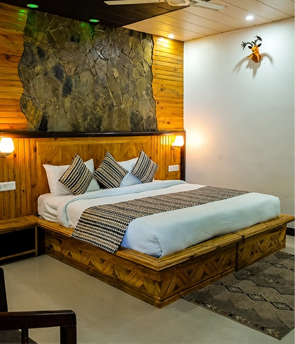 Wood-panelled room with a stone feature wall and double bed