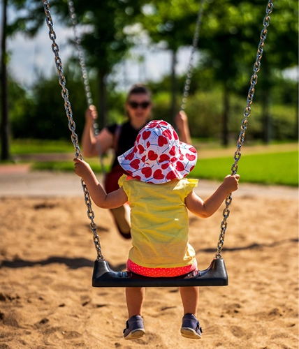 Child on a swing in an outdoor play area
