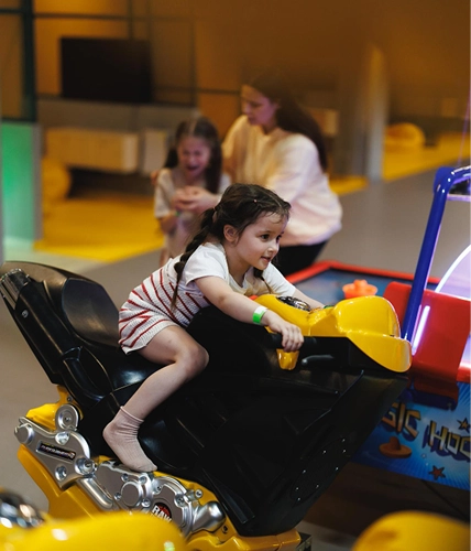 Child enjoying an indoor game ride